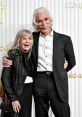 Sam Elliott and a smiling companion pose together at the SAG Awards, showcasing elegance and joy at the event.