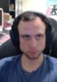 Focused expression of a gamer wearing headphones, representing the energy and intensity associated with "Jackool - Goosely.