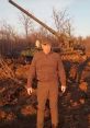 Evgeny Prigozhin stands before a military tank in an outdoor setting, showcasing a moment of military presence.