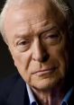 Michael Caine with a thoughtful expression, showcasing his signature style and distinguished features in a close-up portrait.