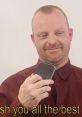 Tim Bradbury from Tiny Tim's Adventures holds a phone, smiling warmly with a message wishing well to viewers.