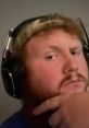 CaseOh deep in thought, wearing headphones, showcasing his streamer persona with a thoughtful expression.