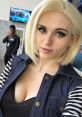 Cosplayer with short blonde hair and striking blue eyes captures a moment at an anime convention, showcasing vibrant style.