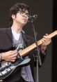 Will Toledo performs passionately at a concert, showcasing his guitar skills and unique style on stage.