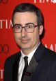 John Oliver at the TIME 100 Gala, showcasing wit and charisma in a stylish tuxedo at a prestigious event.