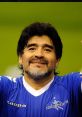 Diego Armando Maradona smiles in a blue jersey during an event, showcasing his iconic charm and passion for football.