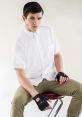 Stylish portrait of a young man in a white shirt with fingerless gloves, showcasing a modern, edgy fashion vibe.