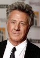 Dustin Hoffman in a classic black suit, showcasing his renowned expression at a film event. Iconic Hollywood actor.
