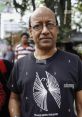 Pratim Bhayade in a black t-shirt featuring the logo of Nu-Age Mime Theatre, outdoors with a blurred background.