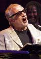 Donald Fagen passionately performing at a live concert, showcasing his unique vocal style and musical talent.