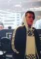 FGTEEV Mike posing in a stylish hoodie at a boxing event, showcasing a confident expression amidst a lively atmosphere.
