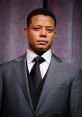 Terrance in a sharp gray suit, exuding confidence on stage with a serious expression, ideal for a professional setting.