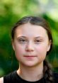 Portrait of Greta Thunberg, young climate activist, with a serene expression against a natural green backdrop.