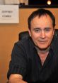 Jeffrey Combs smiles while promoting his role as Ratchet, showcasing his charismatic presence at an event.
