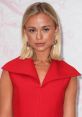 Amelia in a striking red dress with elegant accessories, showcasing a chic and sophisticated style at a recent event.