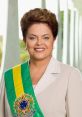 Portrait of Dilma Rousseff, Brazil's first female president, wearing a presidential sash against a light backdrop.