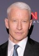 Anderson Cooper with silver hair, wearing a suit and tie, exuding confidence at a CNN event, embodying New, Version 2.0.
