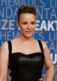Rachel McAdams shines at an event, showcasing her glamorous style in a stunning black dress with elegant makeup.