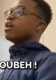 Young person wearing a blue hoodie passionately expressing a point, capturing the energy of "Quoicoubeh!" in action.
