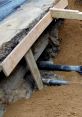 Excavation site showing wooden supports and exposed pipes, essential for construction and main work foundation stability.