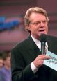 Jerry Springer hosting his iconic talk show, engaging with the audience in a lively studio setting.
