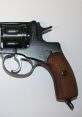 Antique revolver from 1895, featuring a wooden grip and detailed engravings, showcasing historical firearm craftsmanship.