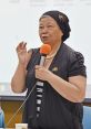 Huafan Du speaking at a conference, sharing insights on culture and community engagement with an audience.