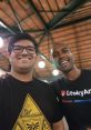 Two friends smiling together, showcasing camaraderie at a tech event, highlighting Tejas Kumar's engaging personality and connections.