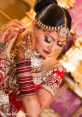 Elegant bridal portrait featuring intricate henna designs, stunning jewelry, and a traditional red wedding outfit.