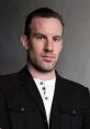 Portrait of a confident man in a stylish black jacket, showcasing strong features and an engaging expression.