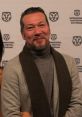 Michael Huang at the International Film Festival Rotterdam, showcasing his signature style and charisma.
