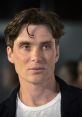 Cillian Murphy with tousled hair and intense gaze, showcasing his striking features at a public event.