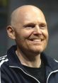 Bill Burr smiling in a casual black jacket, showcasing his charismatic personality and comedic charm.