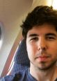 Willyrex takes a selfie on a plane, showcasing his casual style and travel adventures as a popular YouTuber español.