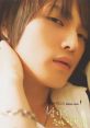 Close-up of a young man with soft features and tousled hair, exuding a charming and stylish vibe. Perfect for jjanan themes.