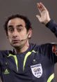 Christopher Iturralde Manriquez officiating a match, signaling a call while wearing a FIFA referee uniform.