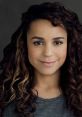 Leilah Stuckey with curly hair and a warm smile, showcasing her approachable and friendly persona. Ideal for acting roles.