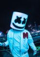 Marshmello performing on stage, wearing a signature light-up mask, engaging fans with high-energy electronic music.
