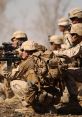 Marines in tactical formation, preparing for deployment, showcasing military readiness and teamwork in a desert environment.