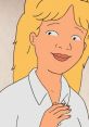 Luanne Platter with a cheerful expression, showcasing her signature blonde hair and warm smile in a casual white shirt.