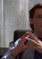Patrick Bateman in an office setting, portraying a confident and calculated demeanor with a professional look.