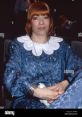 Katja in a stylish blue outfit with white collar, exuding elegance at an event in Germany. Iconic fashion moment.