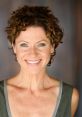 Smiling woman with curly hair in a casual outfit, showcasing a warm and approachable demeanor for Annette (English Australia).