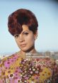 Portrait of a woman with vibrant red hair and floral attire, embodying the fashion of Salome in Colombian culture.