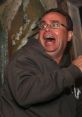 Man with wide eyes and a terrified expression, reacting in shock or fear in a thrilling situation.