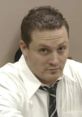 Man in a white shirt and tie looking intensely, embodying a moment of tension related to "Shouting - Jason" theme.