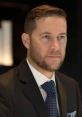 Professional man in a suit with a focused expression, representing confidence and sophistication for "Whispering - Jason.