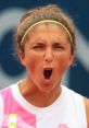 Athlete expressing intense emotion by shouting during a match, conveying determination and competitive spirit.