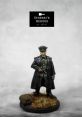 Detailed figurine of a German officer in a long coat, standing on a base with grass and a small animal. Perfect for collectors.